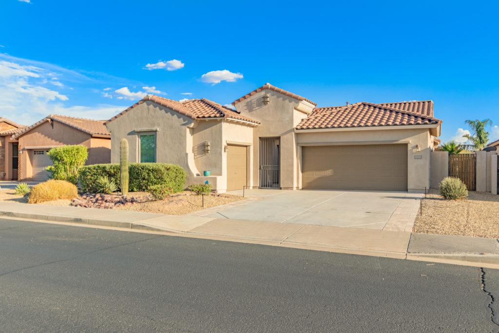 Single level home in Goodyear ( Phoenix Area) Arizona with a generous driveway and split garages for parking 3 vehicles