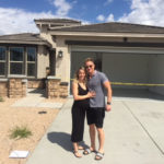 new home buyers in front of their new home in Phoenix AZ