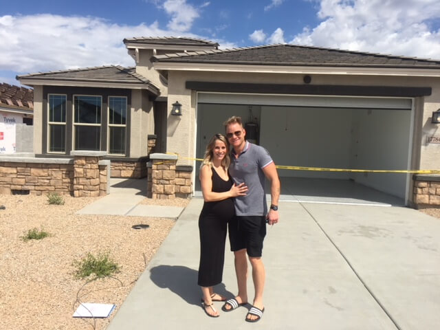 new home buyers in front of their new home in Phoenix AZ
